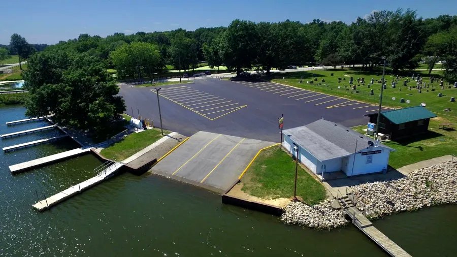 Newly paved Lake Mattoon marina with riprap shoreline and boat slips